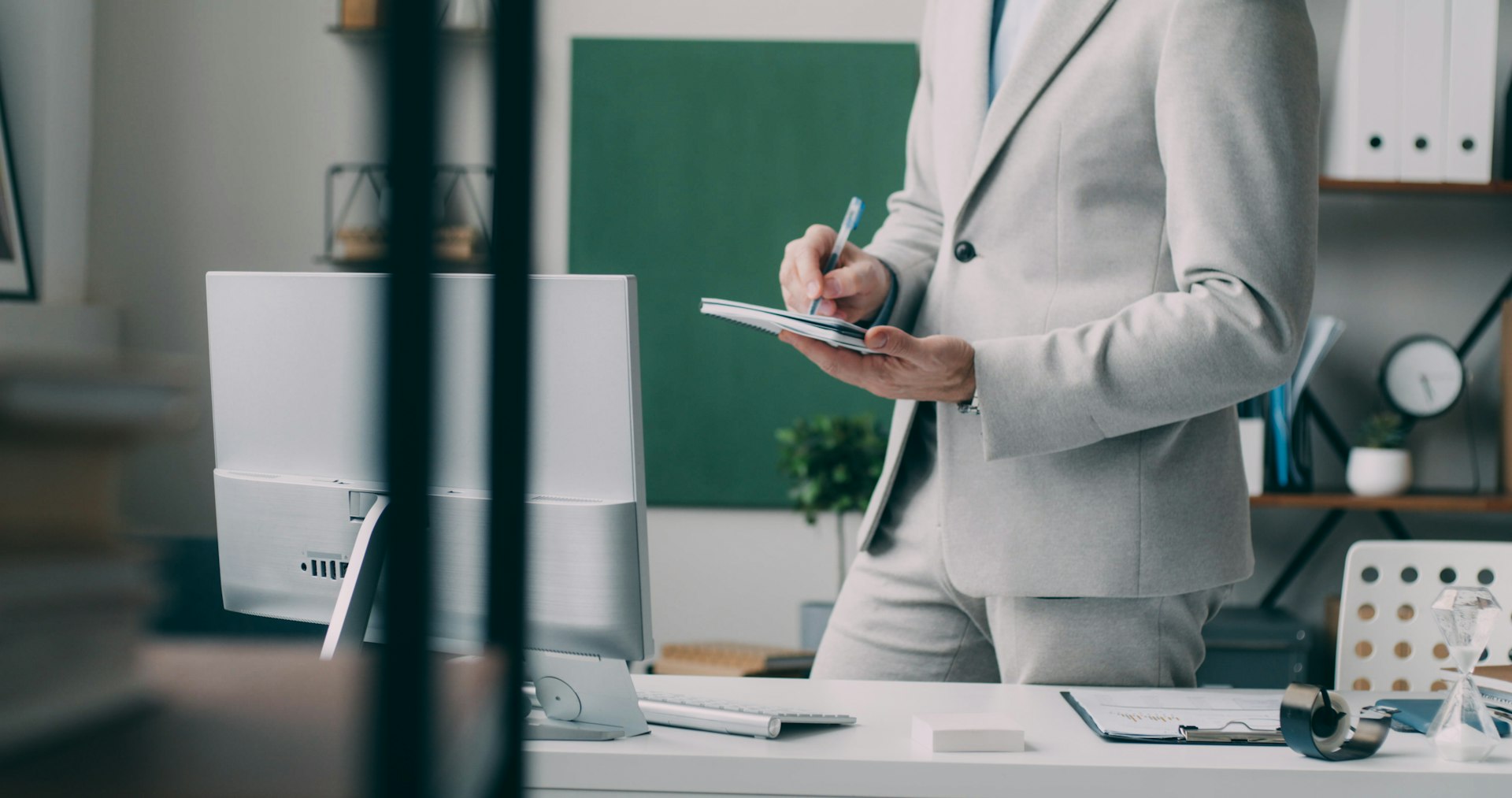 A man in a suit standing in an office
